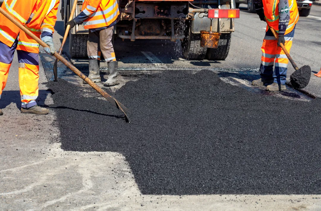 road workers updating part of the road with fresh asphalt